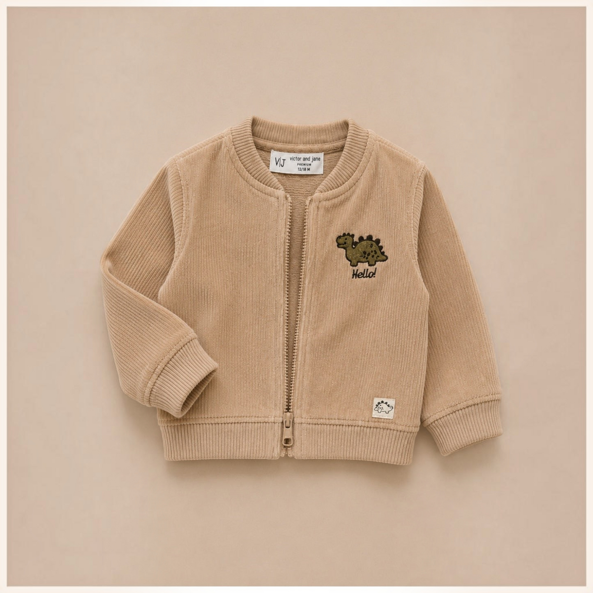 victor and jane beige corduroy zip-up jacket for boys featuring a small embroidered dinosaur and Hello text