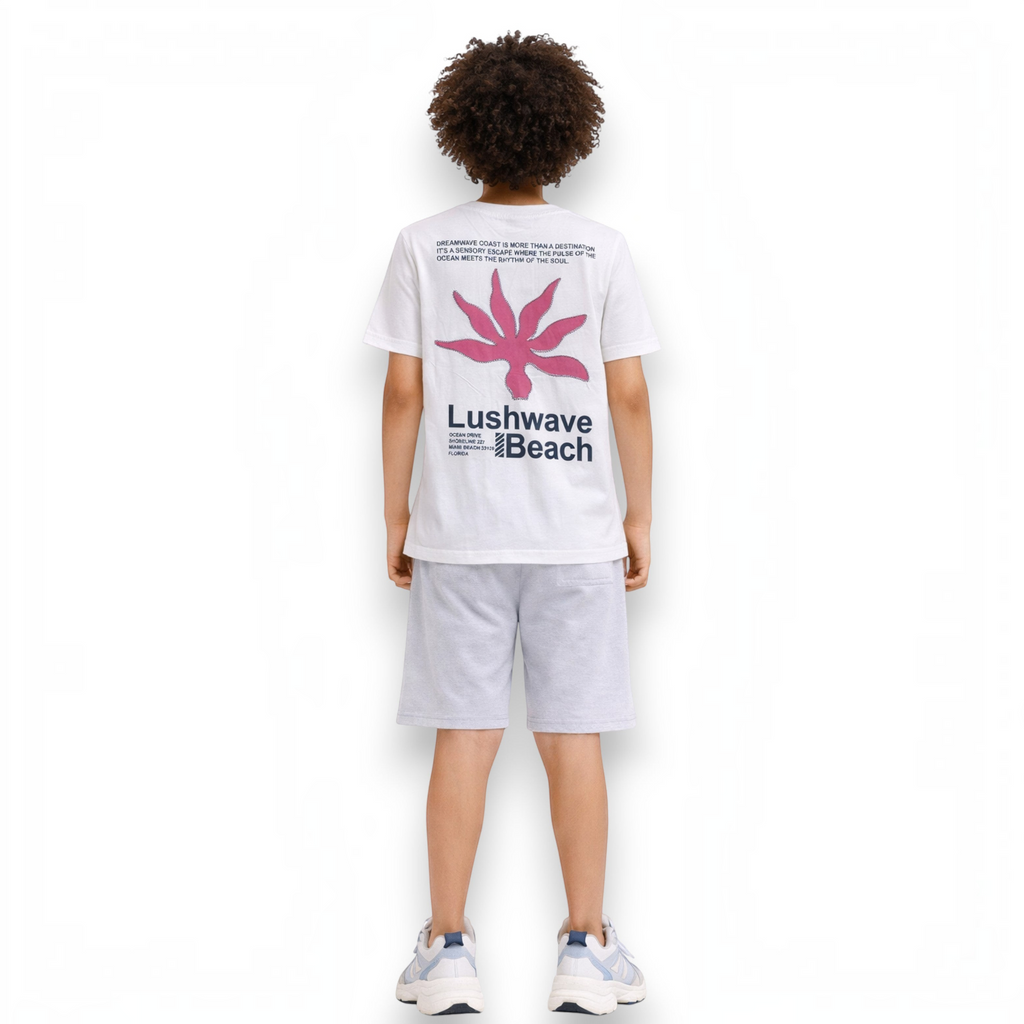 victor and jane boys white graphic t-shirt with pink floral design and text on the back, worn with grey shorts