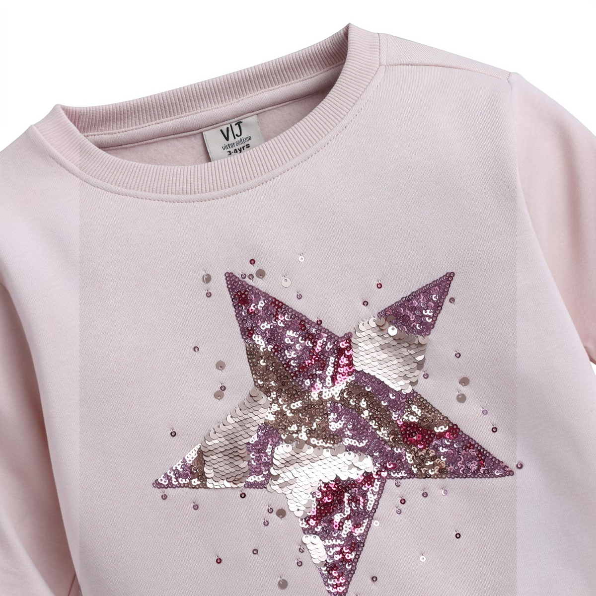 victor and jane girls light pink sweatshirt featuring a large star design made of shimmering purple and silver sequins
