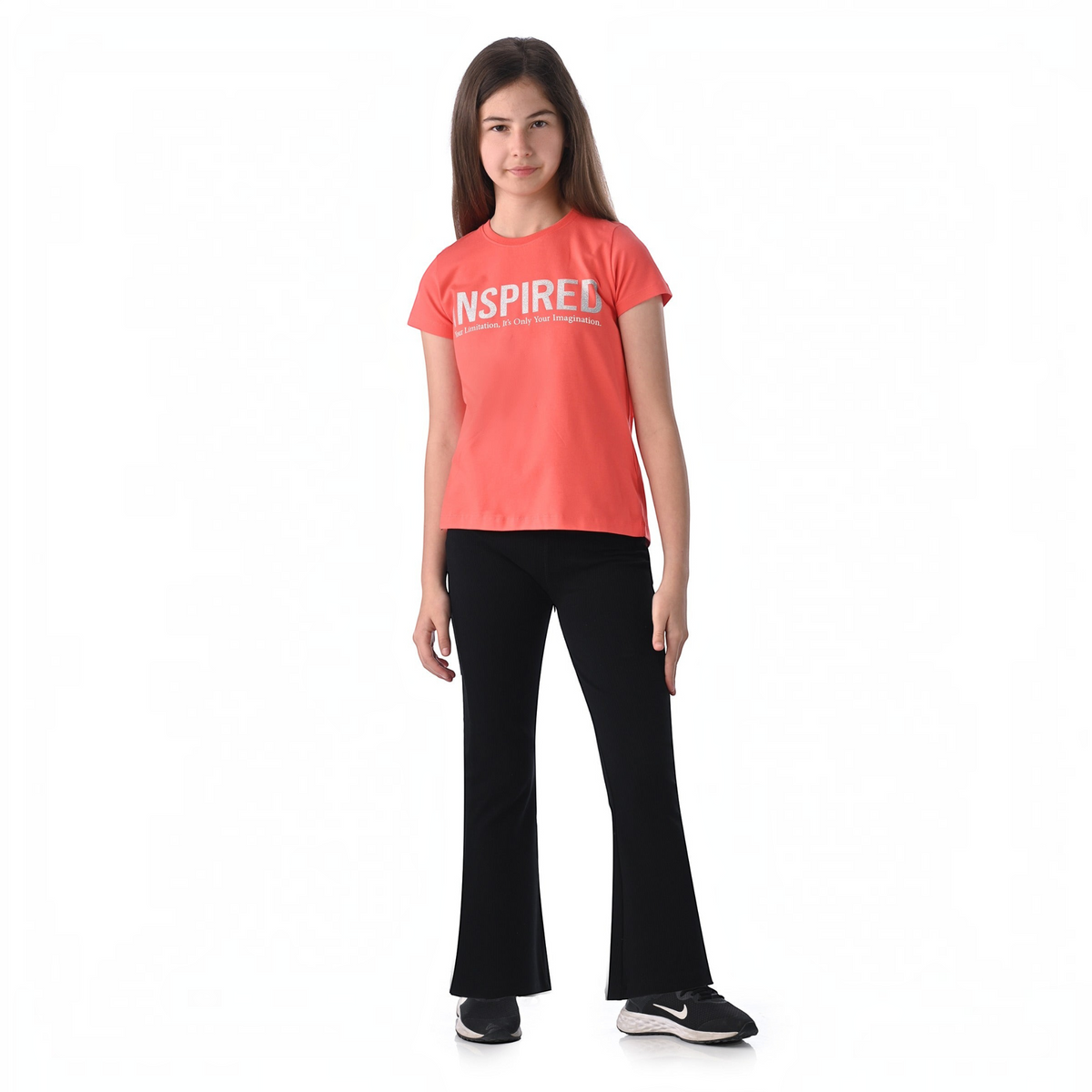 victor and jane girl wearing a coral short-sleeve graphic t-shirt with INSPIRED text and black flared trousers
