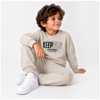 victor and jane boys beige fleece sweatshirt and jogger set with graphic print worn by a young boy