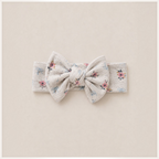 victor and jane baby girl headband in cream with a floral and bow print featuring a large knotted bow detail