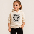Young girl wearing a cream victor and jane Girls Hoodie EURA with a black leopard print live laugh love graphic