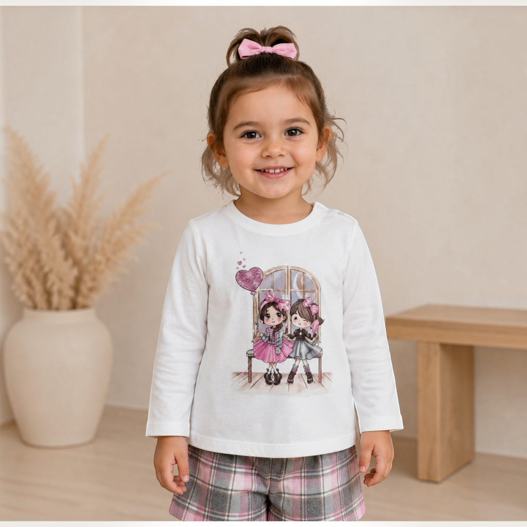 victor and jane girls white long sleeve top with cute cartoon graphic print worn by a smiling toddler