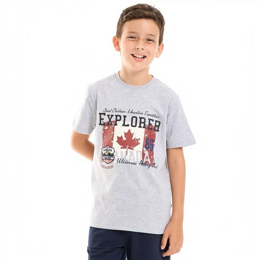 A young boy wearing a victor and jane grey graphic t-shirt featuring a Canadian flag and explorer mountain design.