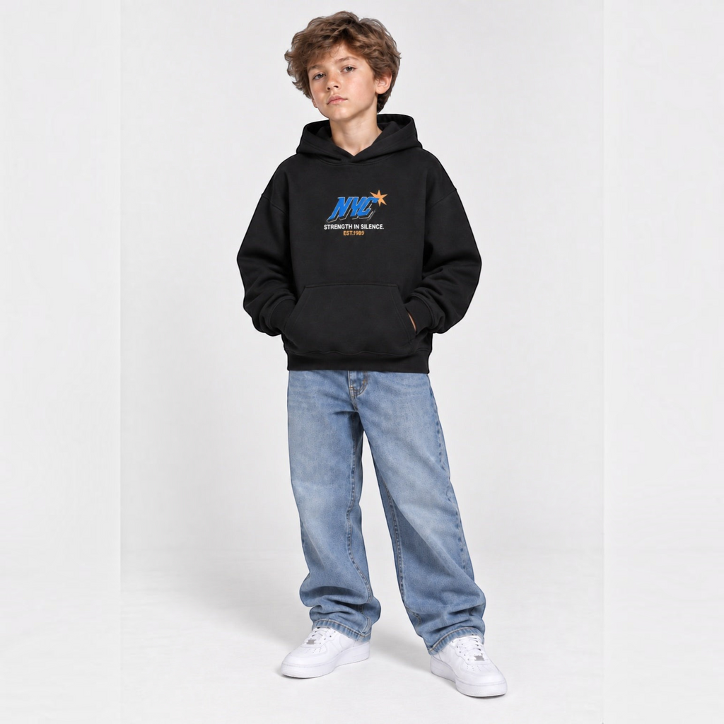 victor and jane boys black fleece hoodie with NYC graphic print, worn by a young boy with light wash jeans