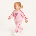 victor and jane toddler girl pink two-piece set with rose embroidery and side ribbon details on a smiling child