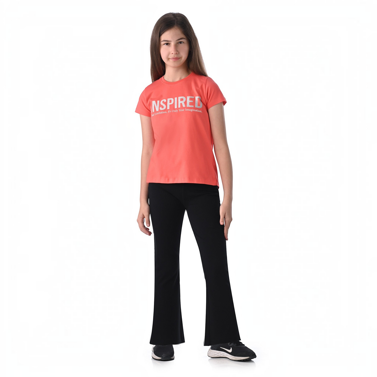 victor and jane girl wearing a coral short-sleeve graphic t-shirt with Inspired text and black ribbed flared pants