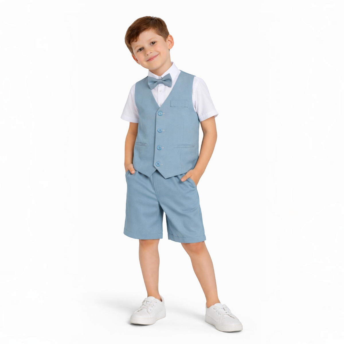 A young boy wearing a victor and jane light blue waistcoat, matching shorts, white shirt, and a bow tie.