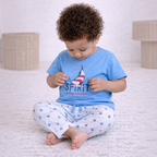 victor and jane baby boy wearing a light blue short-sleeve t-shirt with a sailboat print and striped pajama pants