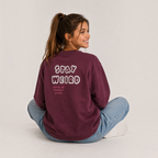 victor and jane girls burgundy fleece pullover with Stay Weird graphic print on the back, worn by a smiling girl