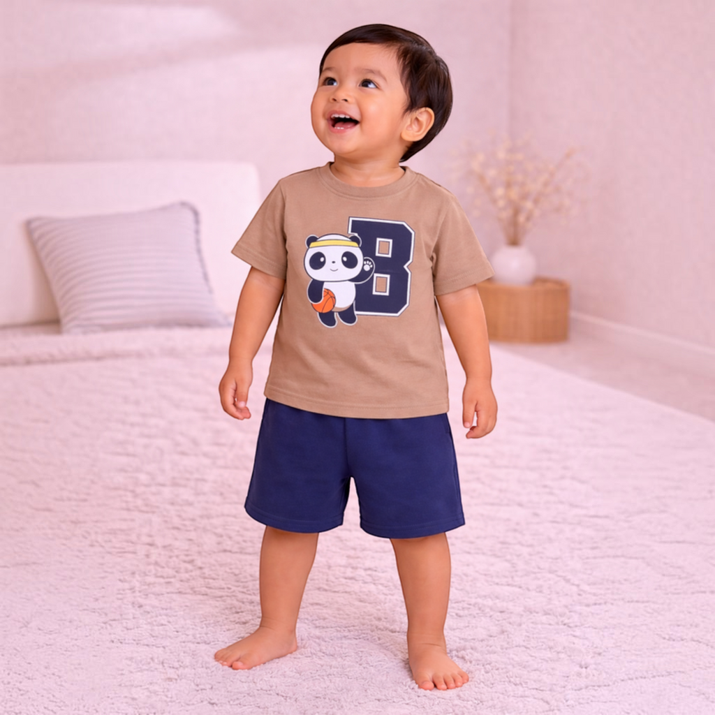 victor and jane boys t-shirt set featuring a tan panda basketball print top and navy blue shorts on a smiling toddler