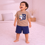 victor and jane boys t-shirt set featuring a tan panda basketball print top and navy blue shorts on a smiling toddler