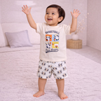 victor and jane boys cream cotton t-shirt and shorts set with basketball panda print standing on a soft rug