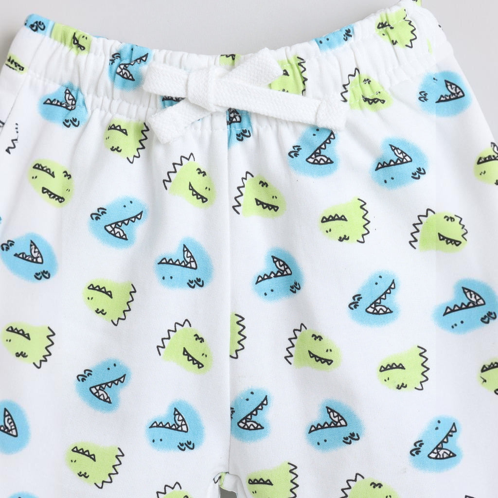 victor and jane boys white shorts with blue and lime green dinosaur print and an elastic drawstring waistband