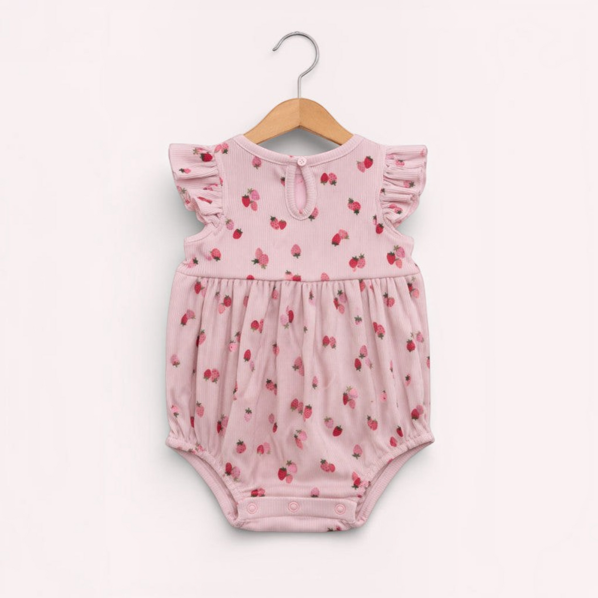 victor and jane baby girls pink ribbed romper featuring a cute strawberry print, ruffled sleeves, and snap closures.