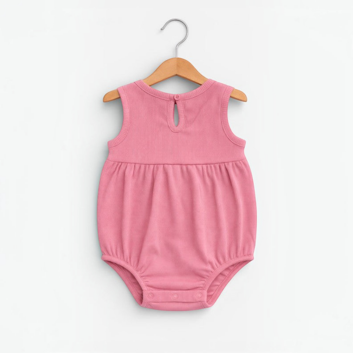 victor and jane baby girls pink ribbed sleeveless romper with back button closure on a wooden hanger