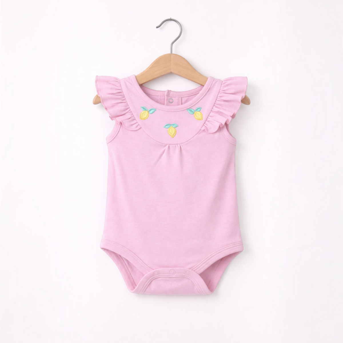 victor and jane baby girls pink cotton bodysuit with flutter sleeves and embroidered lemon details on a hanger