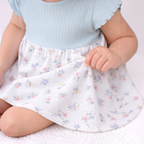 victor and jane baby girls floral skirt with a light blue ribbed bodice and delicate pastel flower print