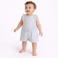 A baby girl wearing a light blue and white striped victor and jane romper with ruffled shoulders and a small bow.