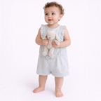 victor and jane baby girl wearing a light blue and white striped sleeveless romper with ruffled shoulders