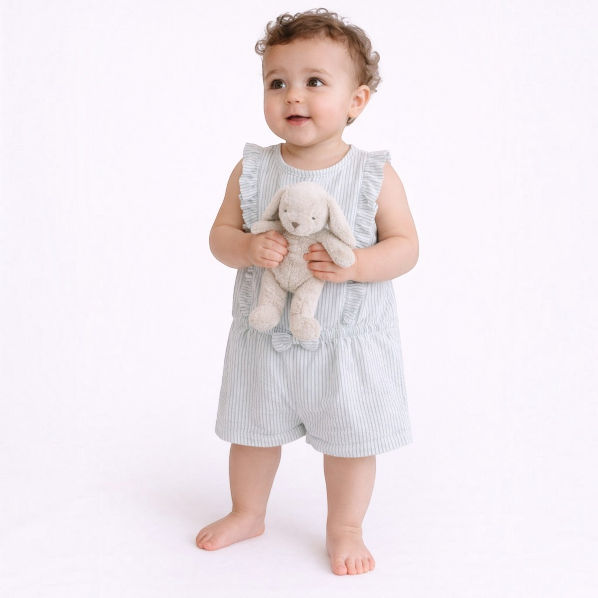 victor and jane baby girl wearing a light blue and white striped sleeveless romper with ruffled shoulders