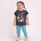 victor and jane toddler girl wearing a charcoal grey cat graphic t-shirt and teal leggings with white ballet flats