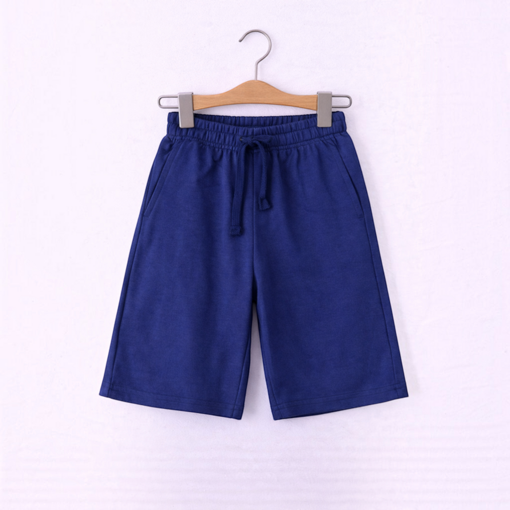 victor and jane boys blue cotton jersey shorts with an elastic drawstring waistband hanging on a wooden hanger