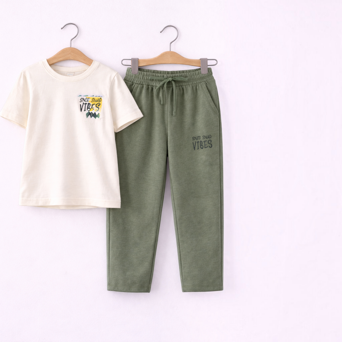 victor and jane boys 2-piece set with cream graphic t-shirt and olive green joggers on wooden hangers
