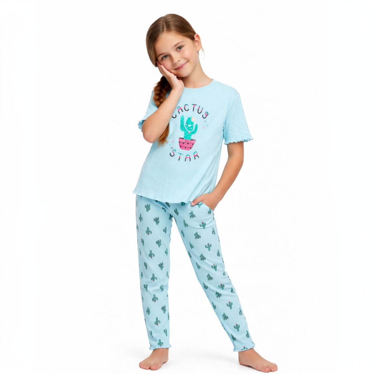 Young girl wearing a light blue victor and jane pyjama set with a cactus print and ruffled sleeves