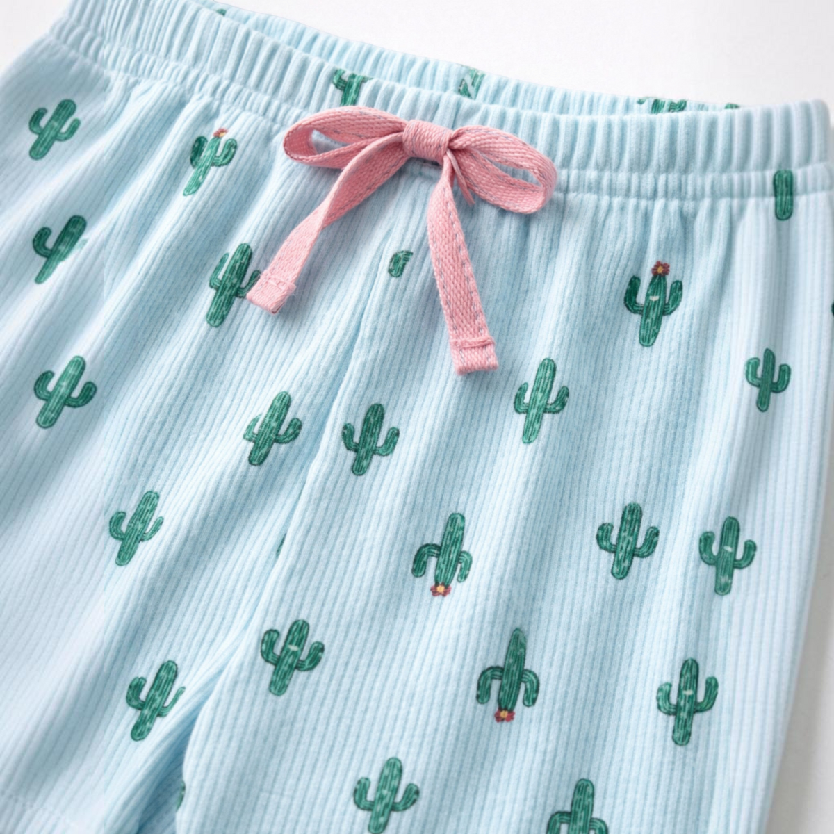victor and jane girls pyjama bottoms in light blue ribbed fabric with a green cactus print and pink drawstring waist