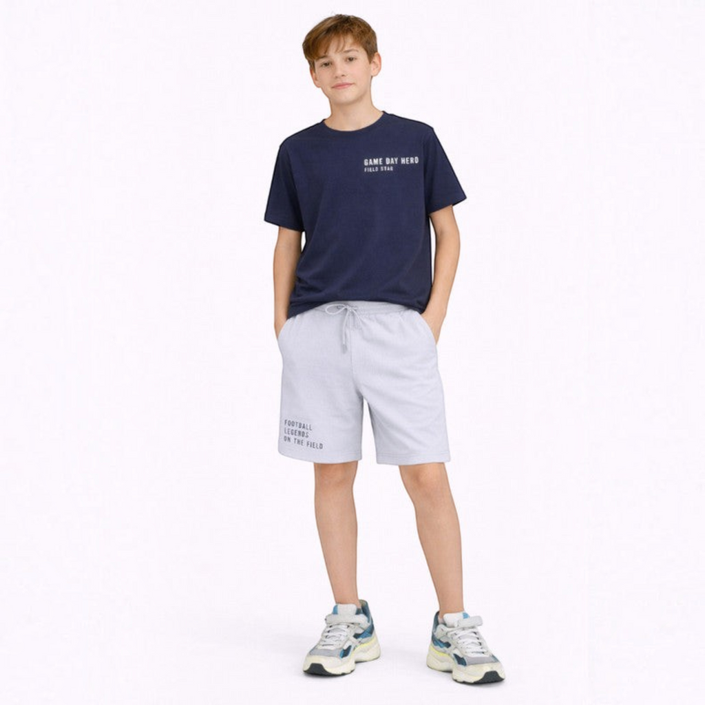 victor and jane boys navy graphic t-shirt and light grey drawstring shorts set worn by a young boy