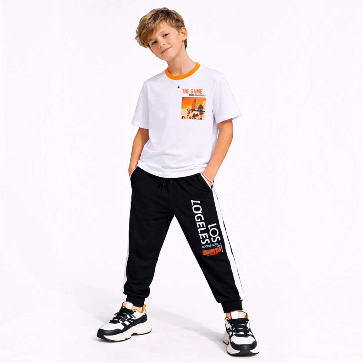victor and jane boys white graphic t-shirt and black joggers set worn by a young boy on a white background
