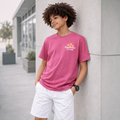 victor and jane boys pink graphic t-shirt with Dreamwave and Coast logo worn by a boy leaning against a wall