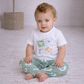 victor and jane baby boy wearing a white graphic t-shirt with a seagull print and matching green patterned pants