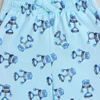victor and jane light blue boys shorts featuring a playful robot print pattern and an elasticated drawstring waist