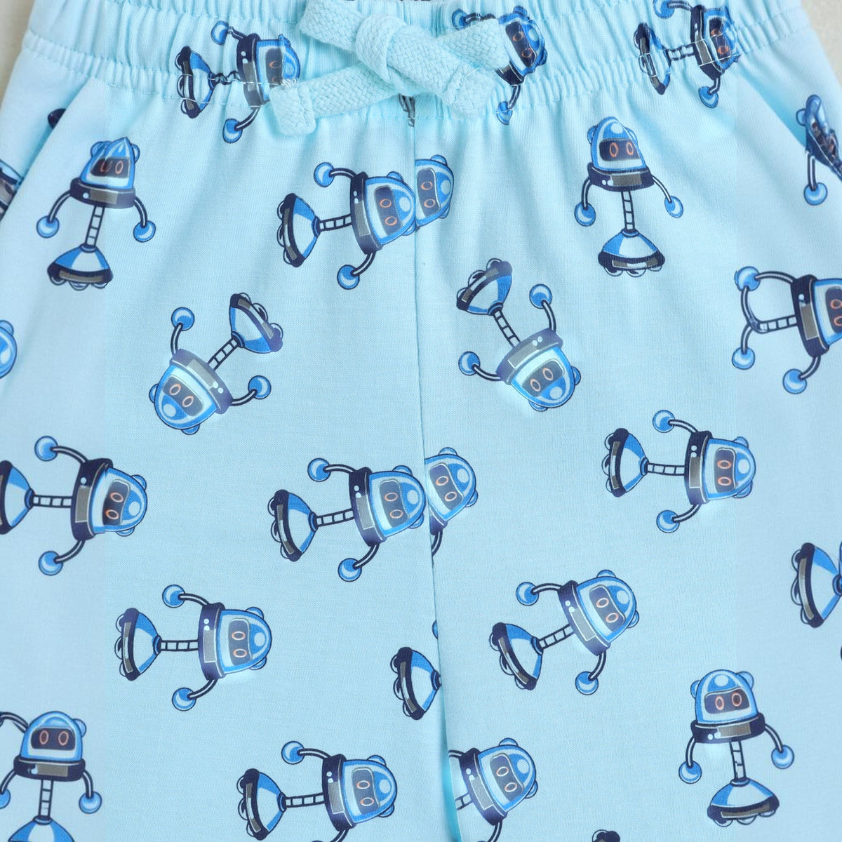 victor and jane light blue boys shorts featuring a playful robot print pattern and an elasticated drawstring waist