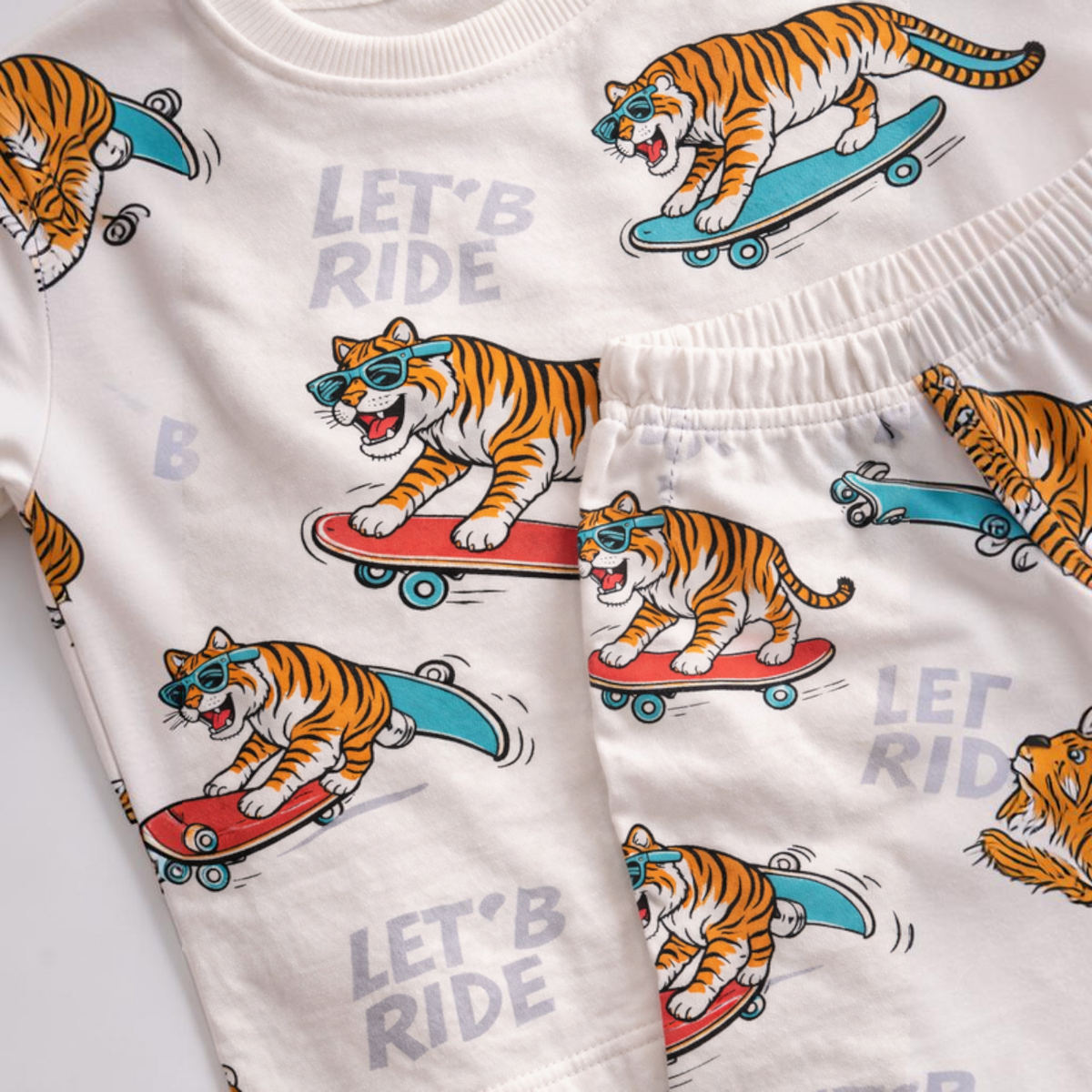victor and jane boys 2pc pyjama set featuring a cream fabric with a playful tiger on skateboard print