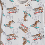 victor and jane boys pyjama set featuring a white fabric with a repeating print of tigers wearing sunglasses skating