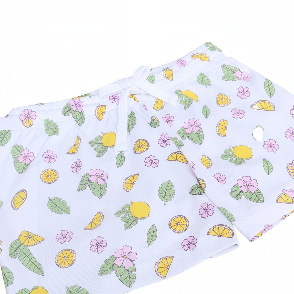 victor and jane girls white shorts featuring a playful lemon, leaf, and pink flower print with an elastic drawstring
