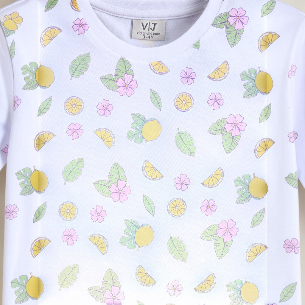 victor and jane girls white t-shirt featuring a playful lemon, leaf, and pink flower print pattern