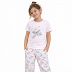 Young girl wearing a victor and jane light pink t-shirt and matching pajama pants with a flamingo and leaf print