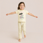 victor and jane girls yellow cartoon t-shirt and floral pajama pants set worn by a smiling child
