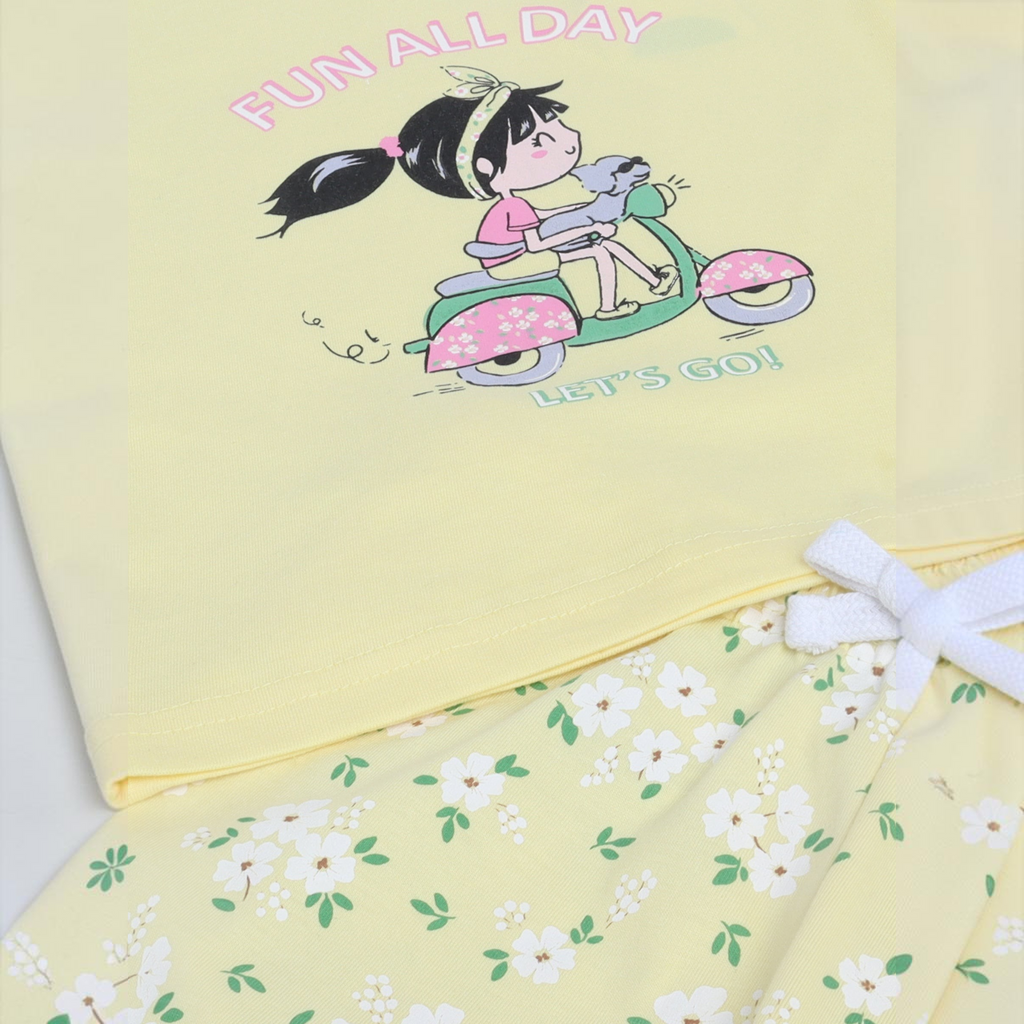 victor and jane girls yellow t-shirt set featuring a cartoon girl on a scooter and white floral print shorts