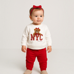 victor and jane 2-piece set for baby girl featuring a white sweatshirt with NYC teddy bear print and red joggers