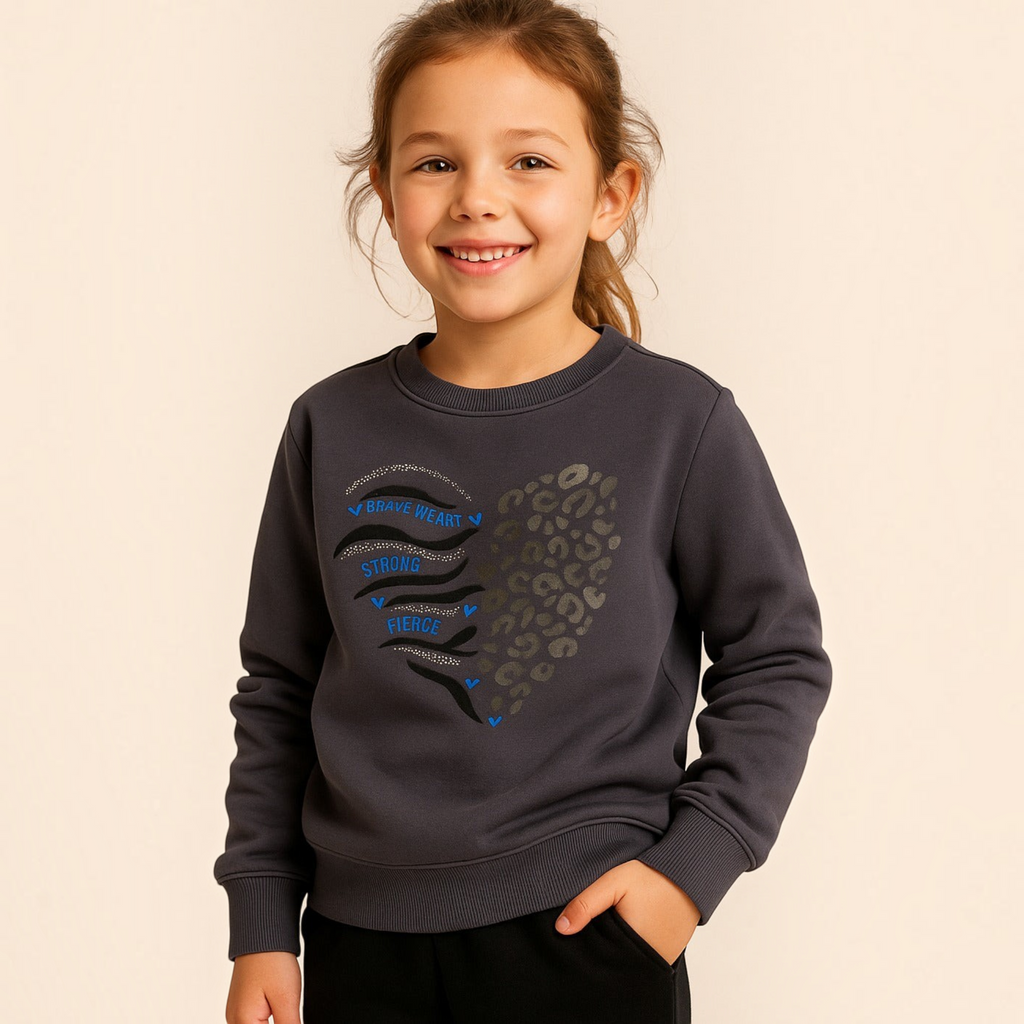 Young girl wearing a victor and jane grey cotton sweatshirt with a Brave Heart graphic and leopard print design