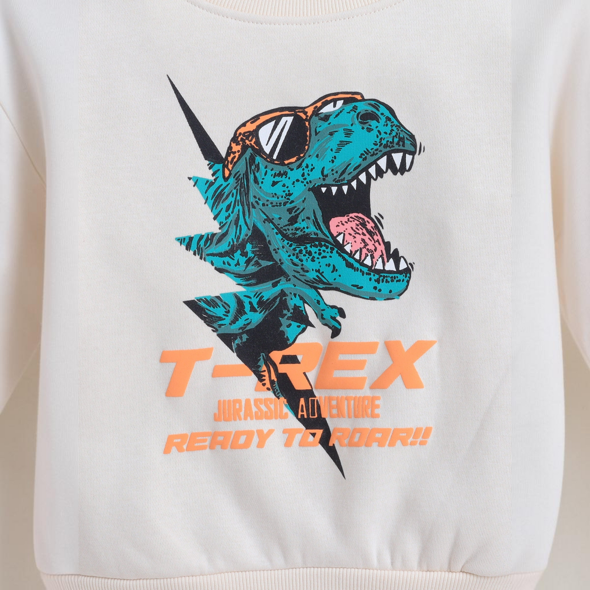 victor and jane boys cream sweatshirt featuring a teal T-Rex graphic wearing sunglasses with orange text