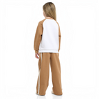 A girl wearing a victor and jane two-piece set featuring a brown and white raglan sweatshirt and matching joggers.